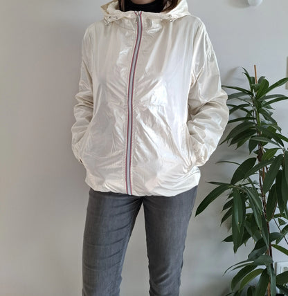 Woman wearing a shiny white Laura Jo raincoat with striped zipper, casual outfit, indoor plant