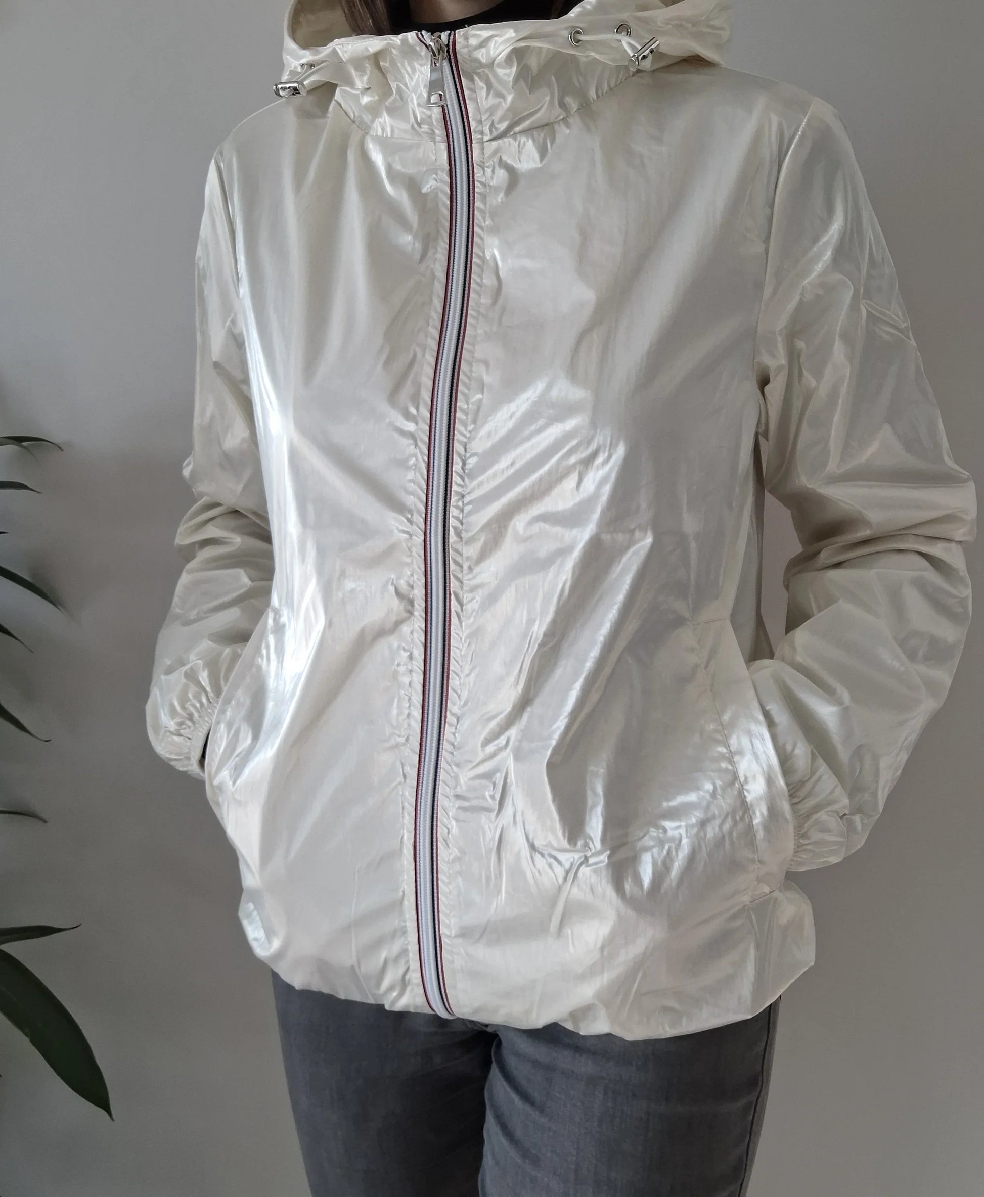 Woman wearing shiny white Laura Jo rain jacket with hood, Le Petit Placard fashion