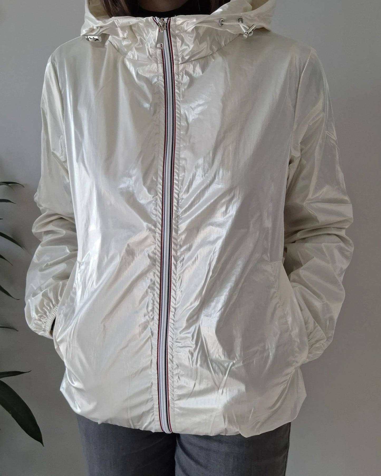 Shiny cream Laura Jo raincoat with striped zipper, shown on model, Le Petit Placard