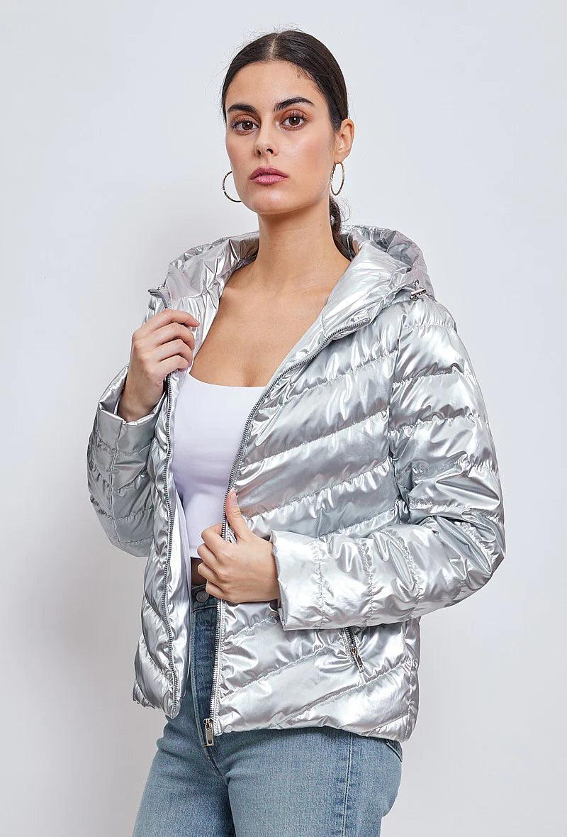 Woman wearing a short silver quilted jacket with hood from Le Petit Placard
