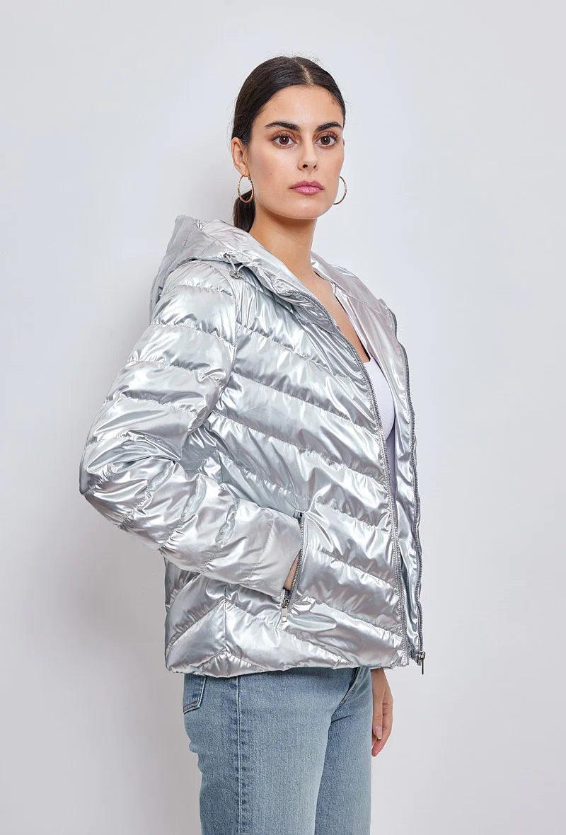 Woman wearing a silver quilted short jacket with hood from Le Petit Placard