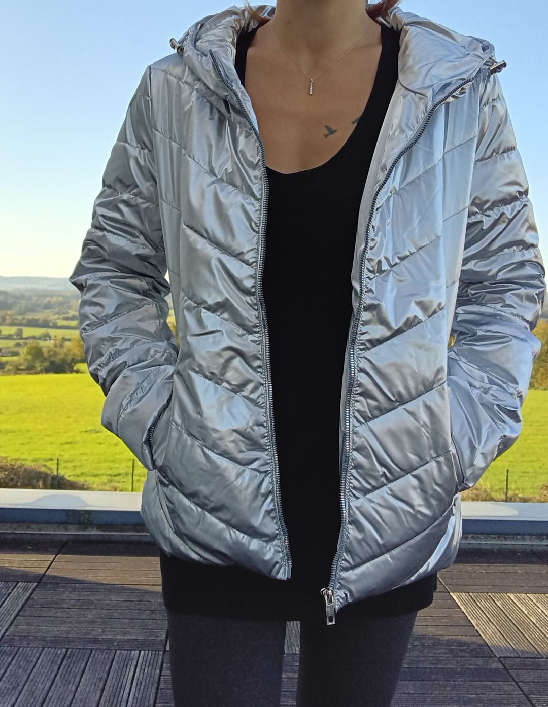 Woman wearing a shiny silver Laura Jo rain jacket outdoors, Le Petit Placard fashion