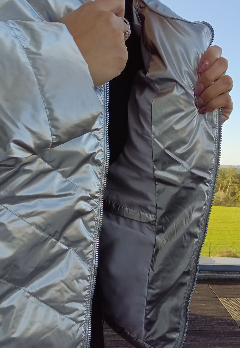 Close-up of silver quilted Laura Jo raincoat from Le Petit Placard with inner pocket detail