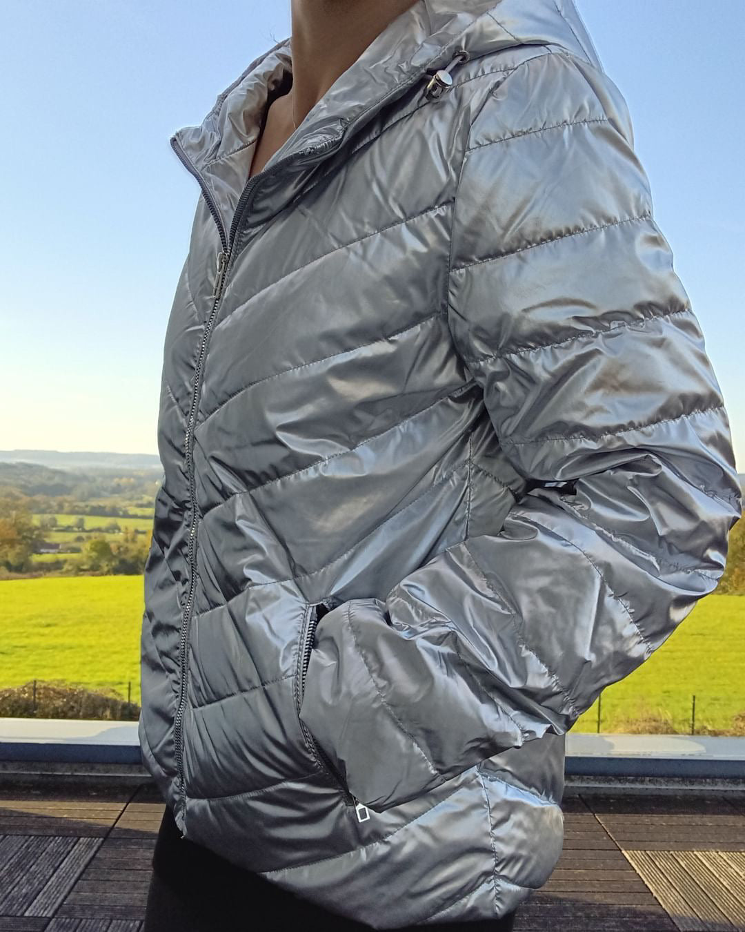 Woman wearing metallic silver Laura Jo puffer jacket outdoors, Le Petit Placard fashion