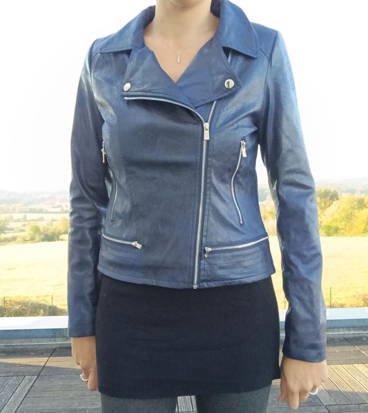 Woman wearing a stylish blue faux leather jacket outdoors, Le Petit Placard fashion