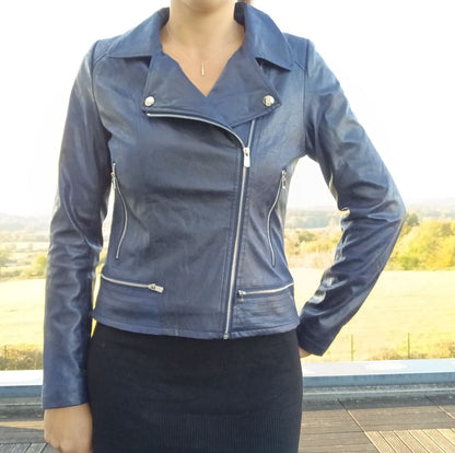 Woman wearing stylish blue faux leather jacket outdoors, Le Petit Placard fashion