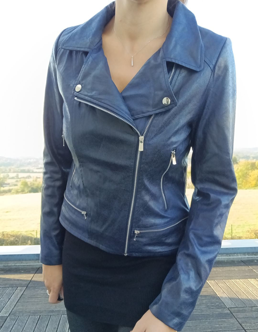 Woman wearing navy blue perfecto jacket from Le Petit Placard outdoors