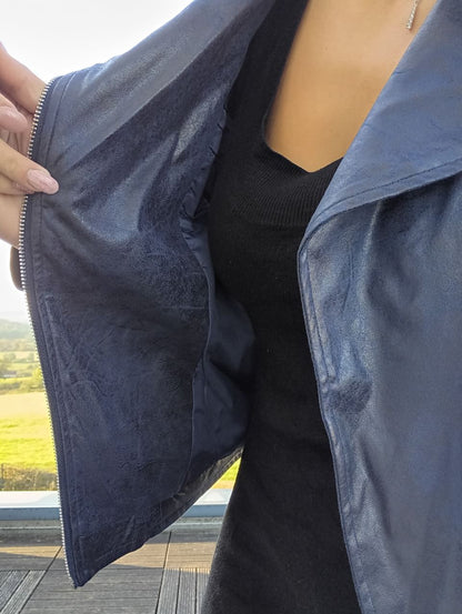 Woman showing inside of navy blue perfecto jacket from Le Petit Placard outside