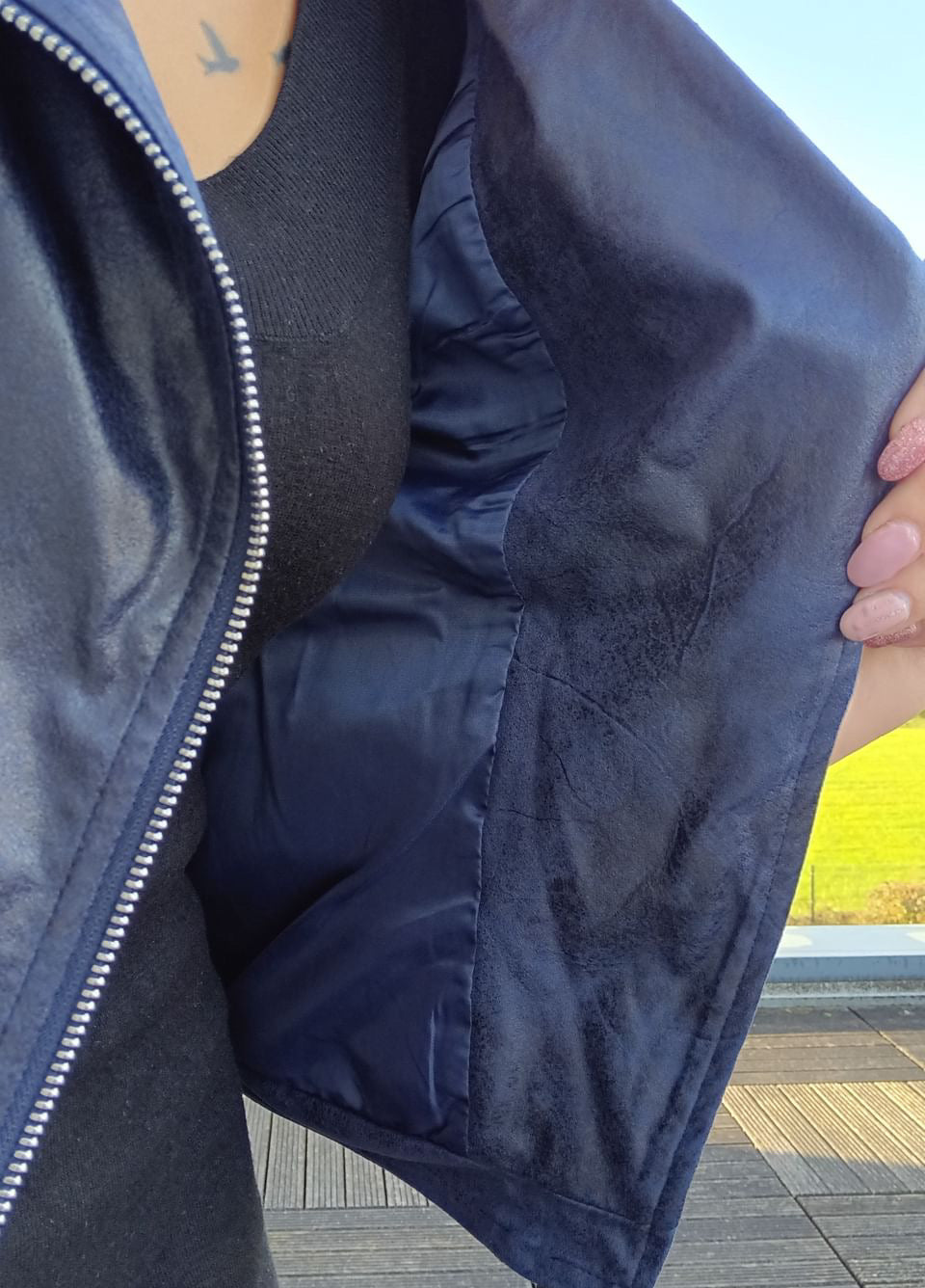 Detail of navy blue perfecto jacket lining from Le Petit Placard in natural light