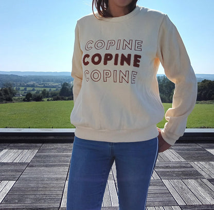 Woman in cream COPINE sweatshirt and jeans standing outdoors, Le Petit Placard fashion style