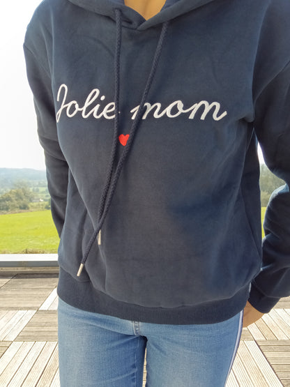 Navy blue hoodie with 'Jolie mom' embroidery, worn outdoors, Le Petit Placard fashion.
