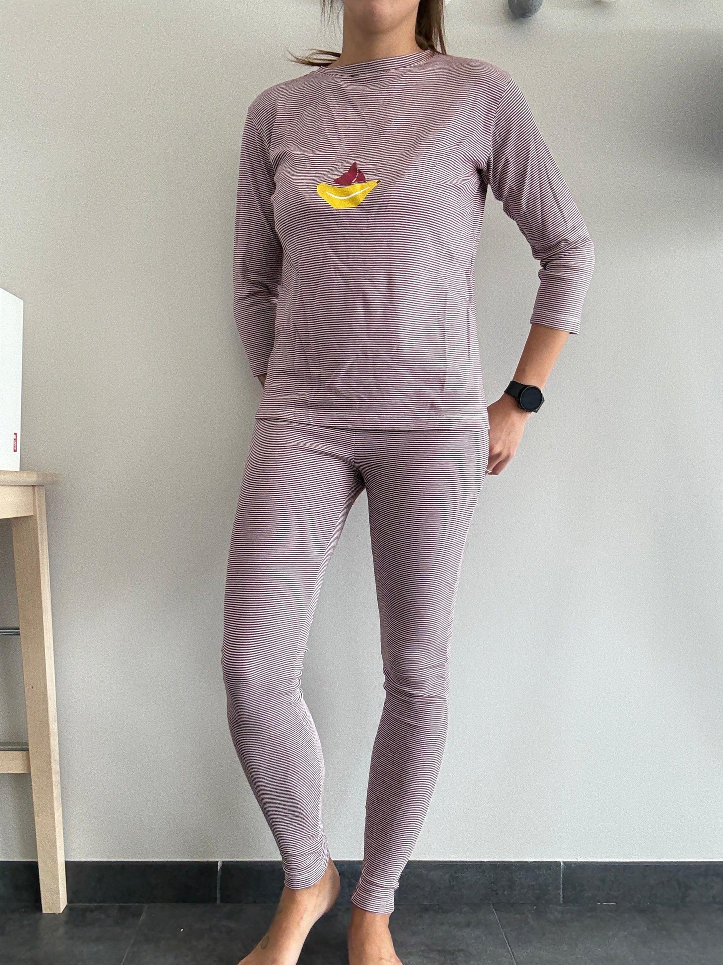 Woman wearing striped pink pyjama set with boat motif, Le Petit Placard fashion