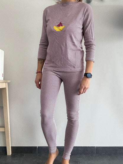Woman wearing pink striped pyjama set with boat print, Le Petit Placard homewear style
