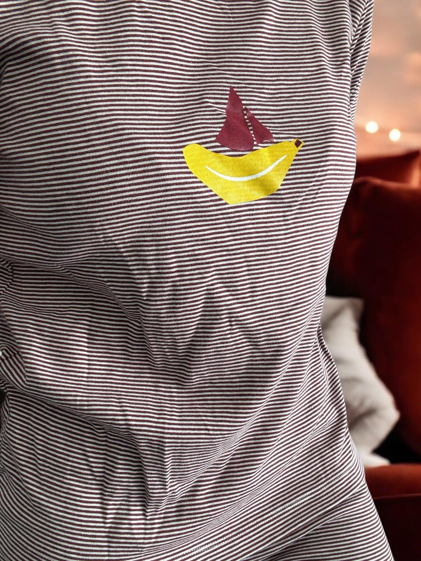 Striped t-shirt with yellow banana and red sailboat print, close-up, Le Petit Placard