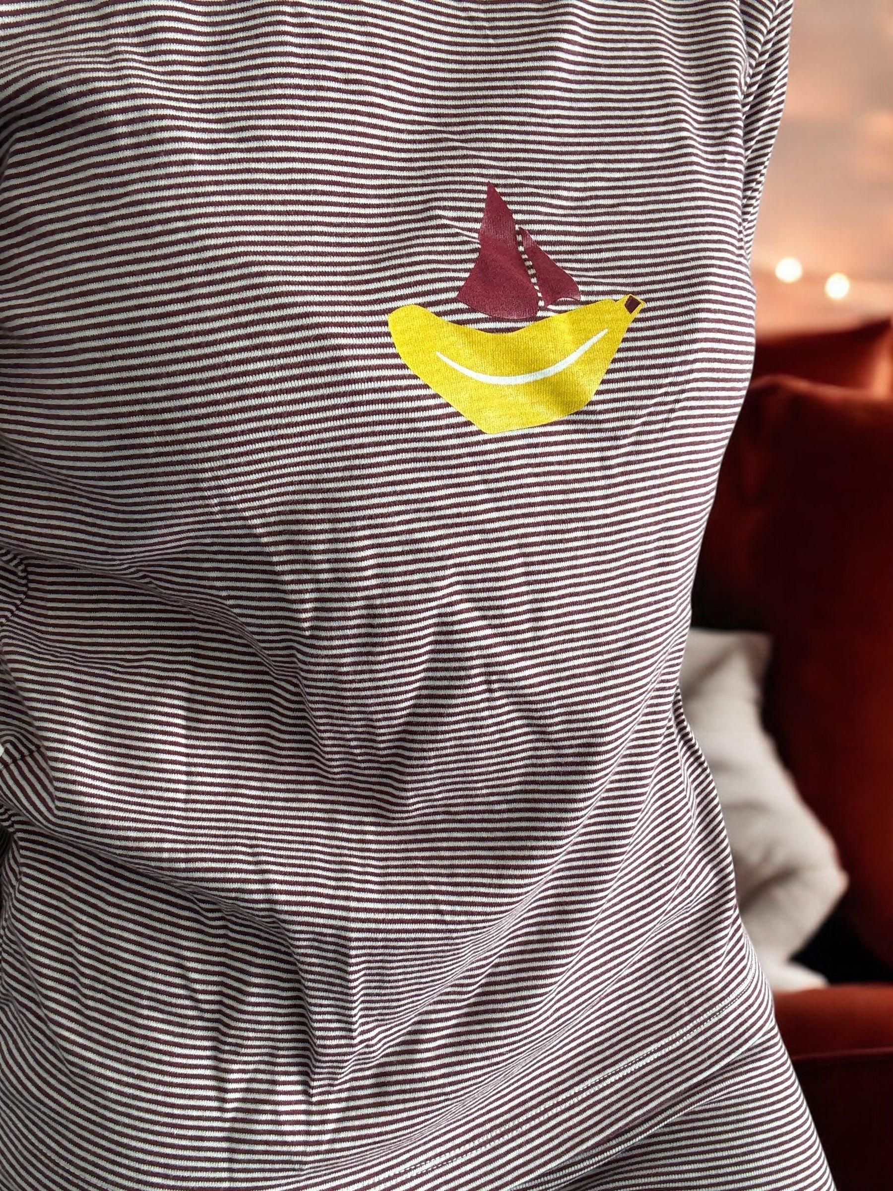 Striped t-shirt with yellow banana and red sailboat print, close-up, Le Petit Placard
