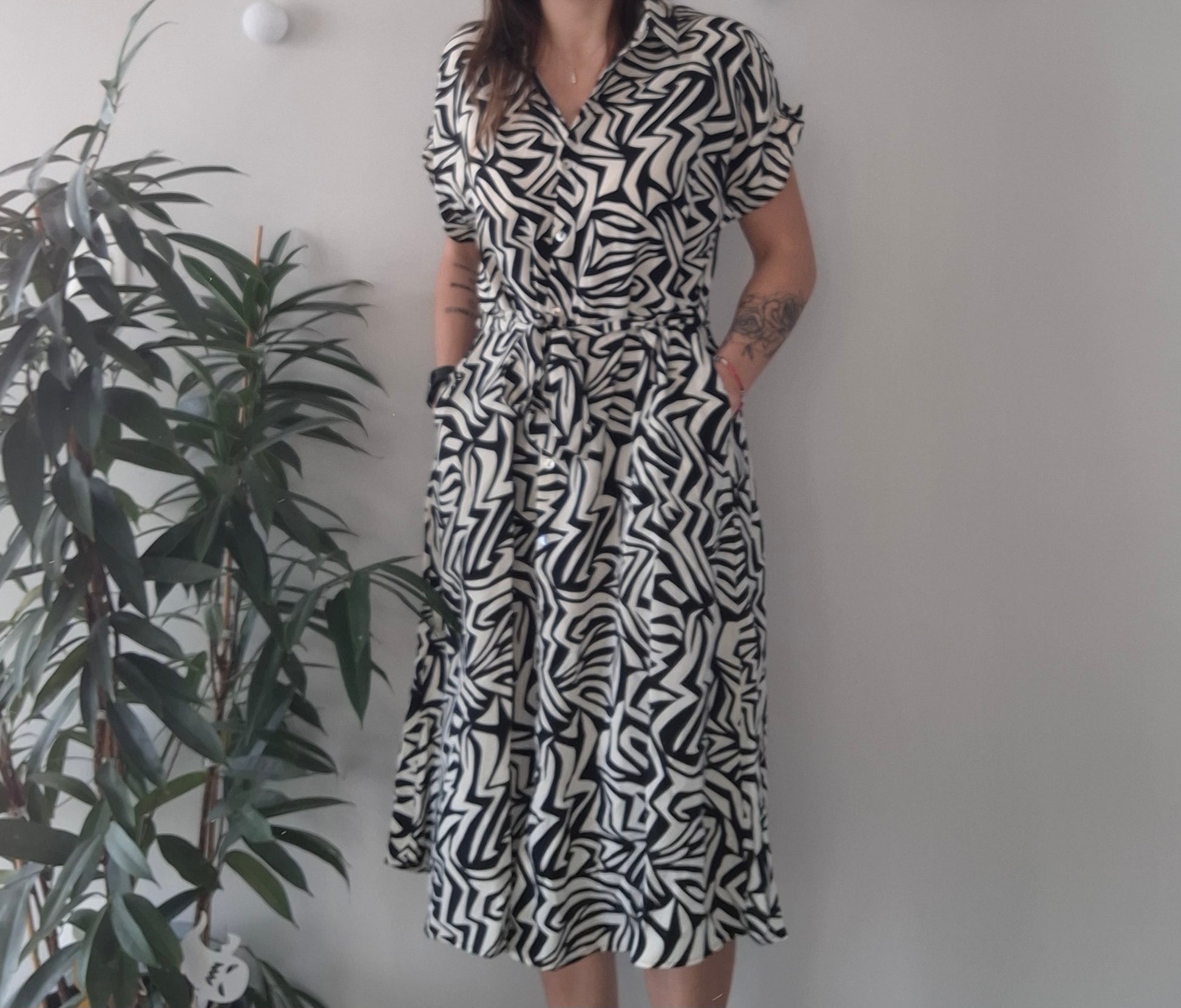 Woman wearing black and white abstract print dress from Le Petit Placard