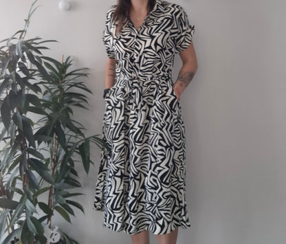 Woman wearing black and white abstract print dress from Le Petit Placard