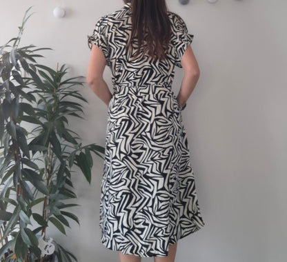 Woman in black and white patterned dress, Le Petit Placard boutique fashion, indoor plant decor