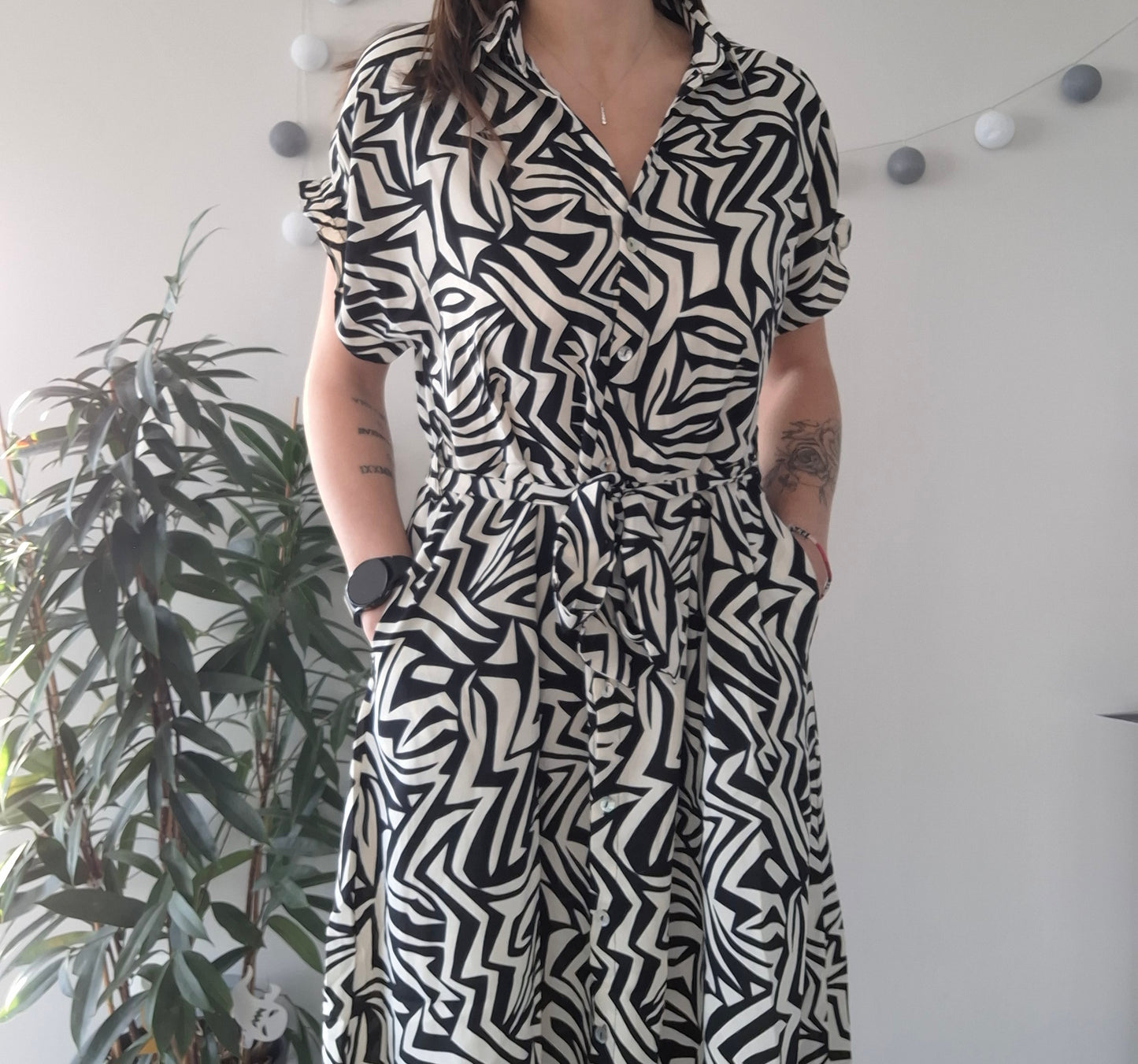 Woman wearing a black and white geometric patterned dress from Le Petit Placard