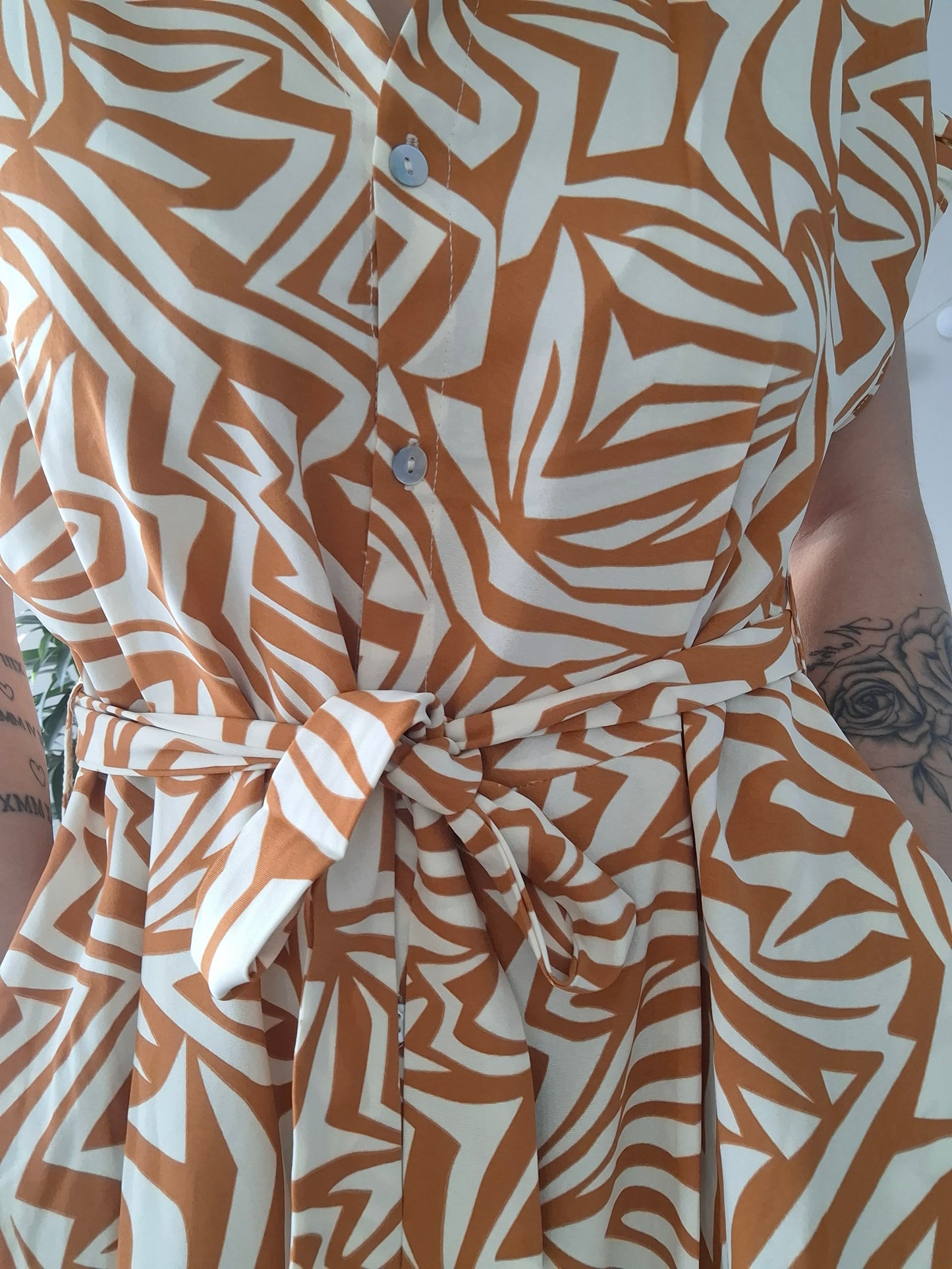 Orange and white geometric print dress with belt, Le Petit Placard fashion accessory.