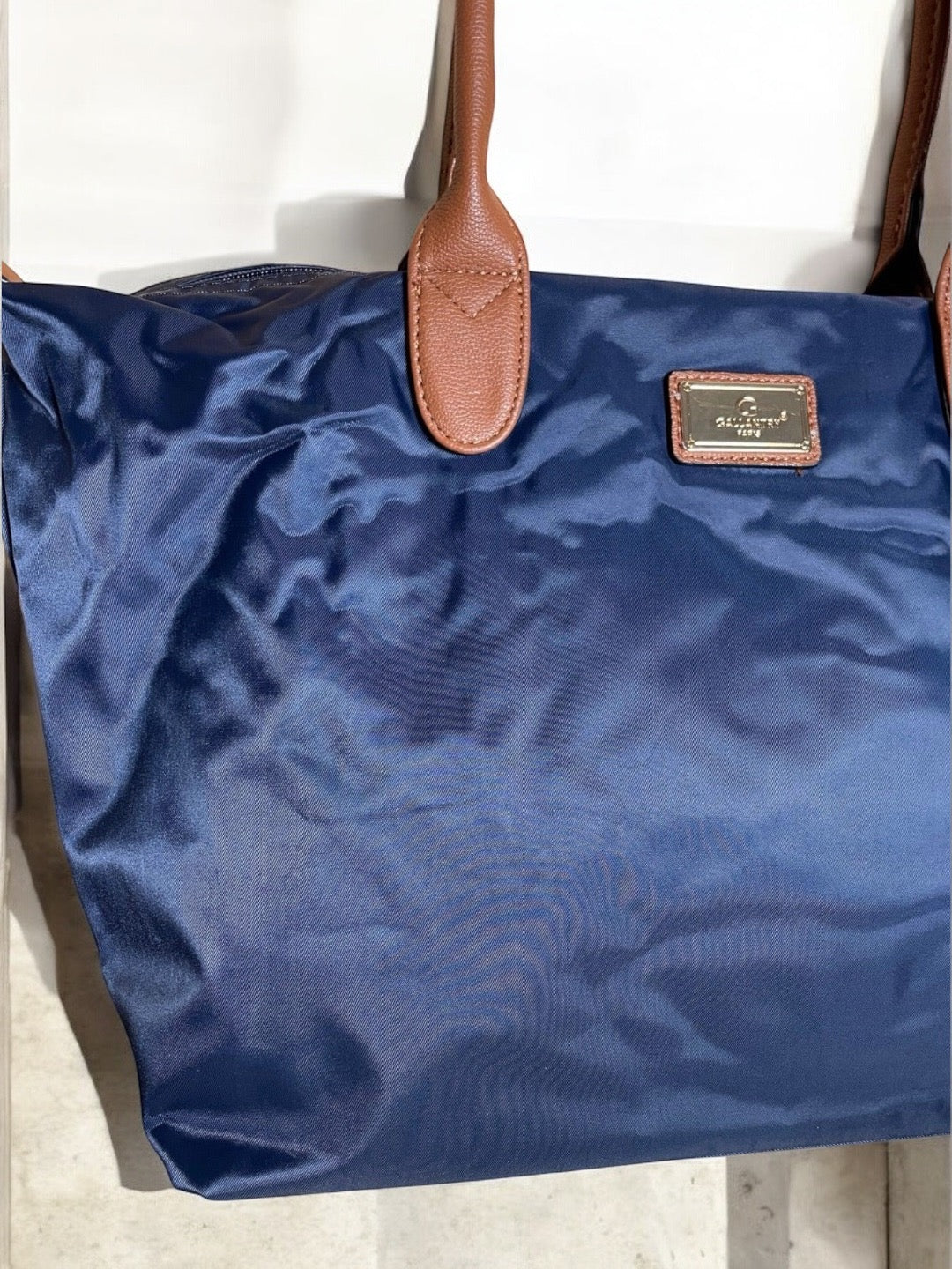 Sac à main fourre-tout bleu marine en nylon avec anses en cuir marron et plaque dorée décorative