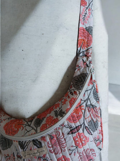 Floral quilted bum bag with pink and red flower print, displayed on a white mannequin