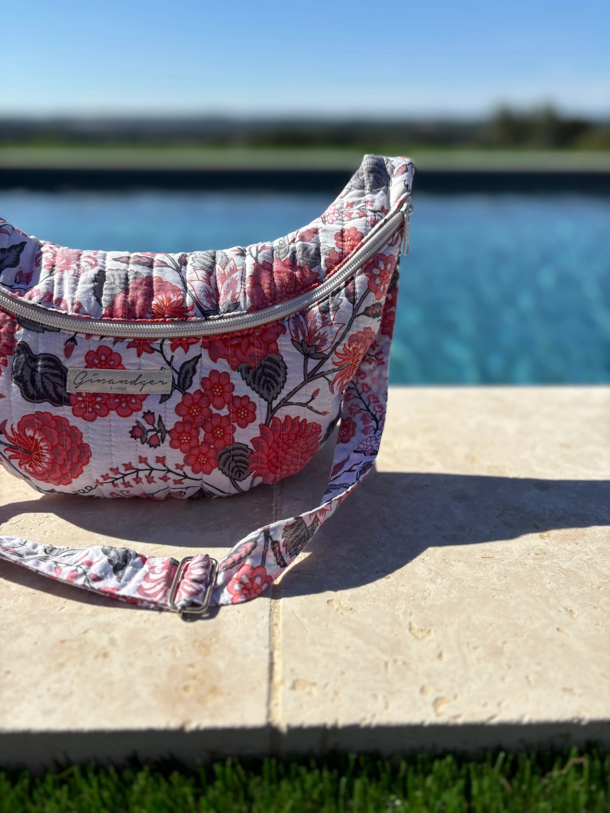 Floral fabric bum bag by a pool, trendy accessory from Le Petit Placard