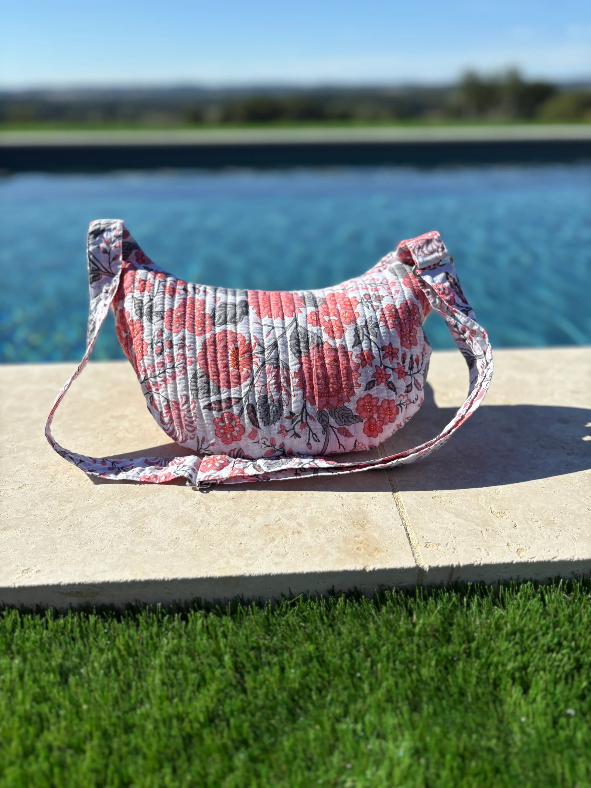 Floral quilted shoulder bag, trending accessory from Le Petit Placard, by a poolside