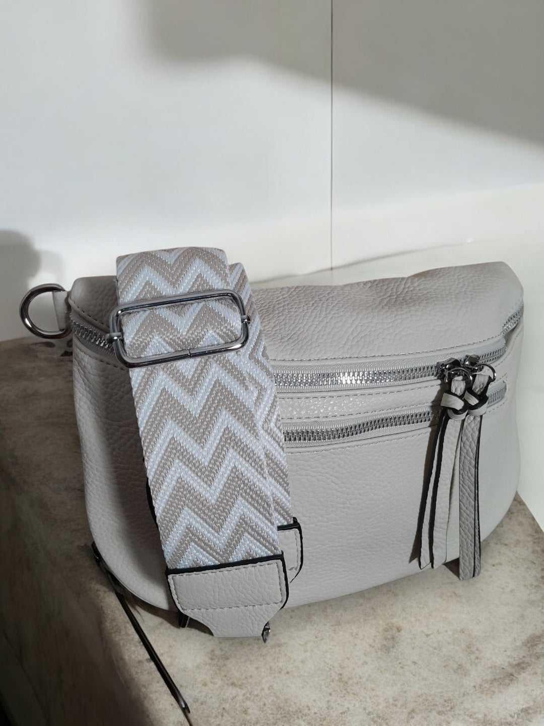 Trendy grey leather bum bag with chevron strap from Le Petit Placard accessories collection