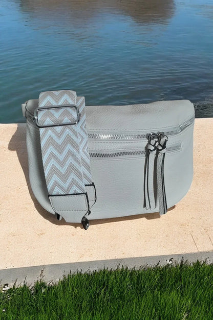 Trendy light gray bum bag with chevron strap on stone by water, Le Petit Placard accessories