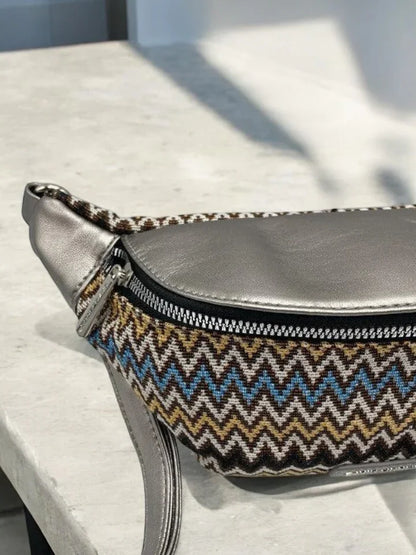 Trendy zigzag patterned and silver faux leather bum bag on stone surface from Le Petit Placard