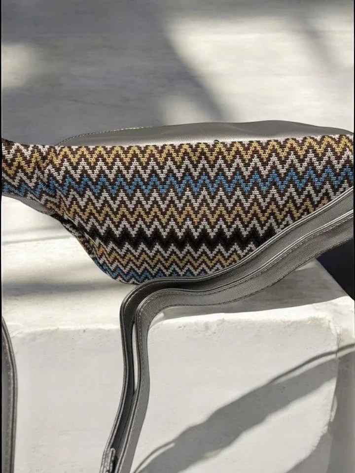 Chevron-patterned sac banane with metallic strap on white surface, Le Petit Placard accessory