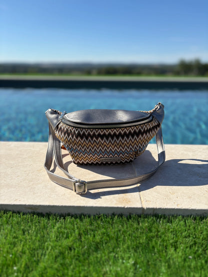 Trendy zigzag patterned sac banane on stone ledge by a pool, Le Petit Placard accessory