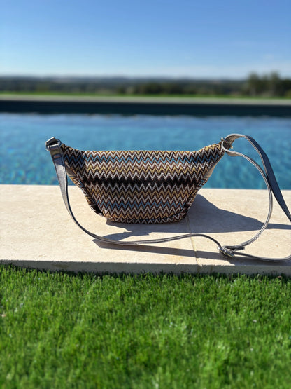 Trendy zigzag patterned sac banane on poolside at Le Petit Placard, outdoor daylight shot