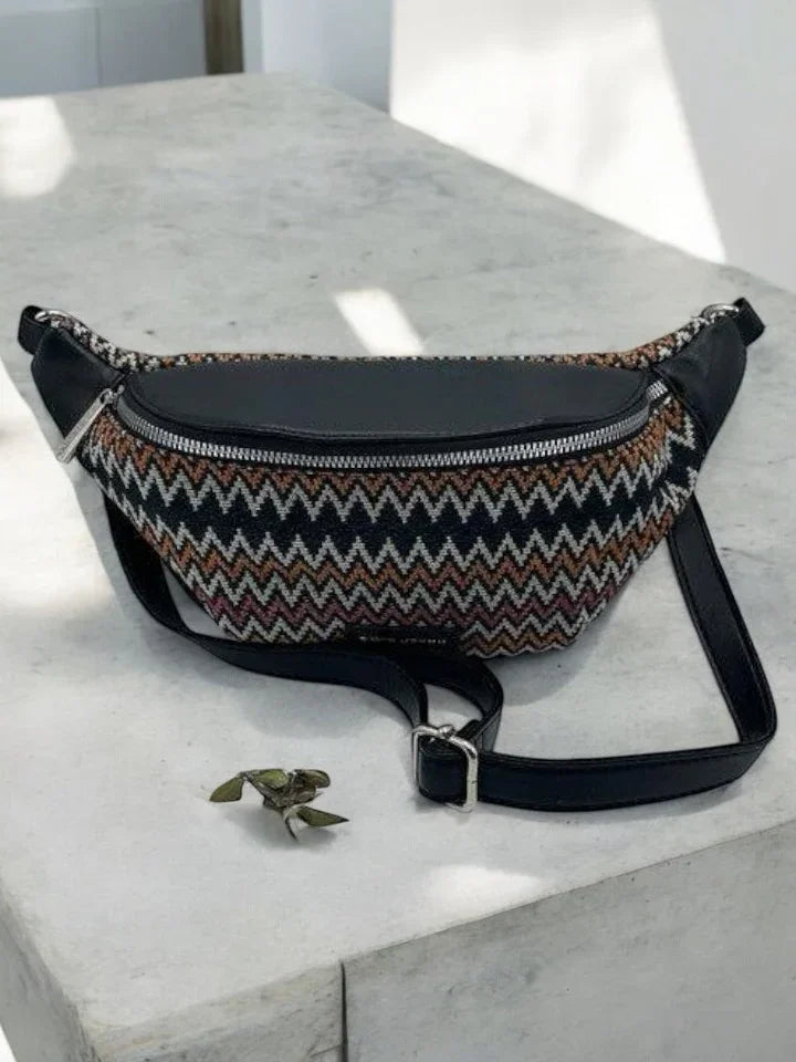 Trendy zigzag-patterned sac banane with black leather trim on a stone surface, Le Petit Placard.