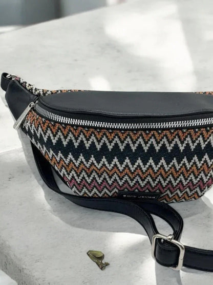 Trendy zigzag-patterned sac banane with black leather trim on a light surface, Le Petit Placard