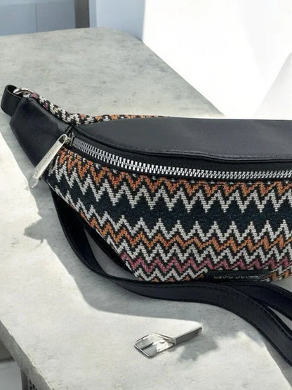 Patterned zigzag fabric and black leather belt bag on table, trendy accessory at Le Petit Placard
