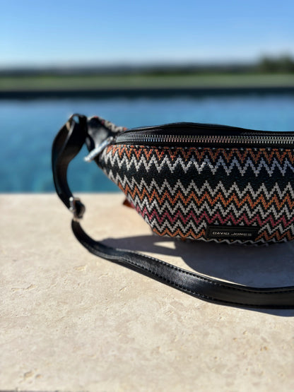 David Jones zigzag patterned sac banane on stone surface by water, trendy accessory Le Petit Placard