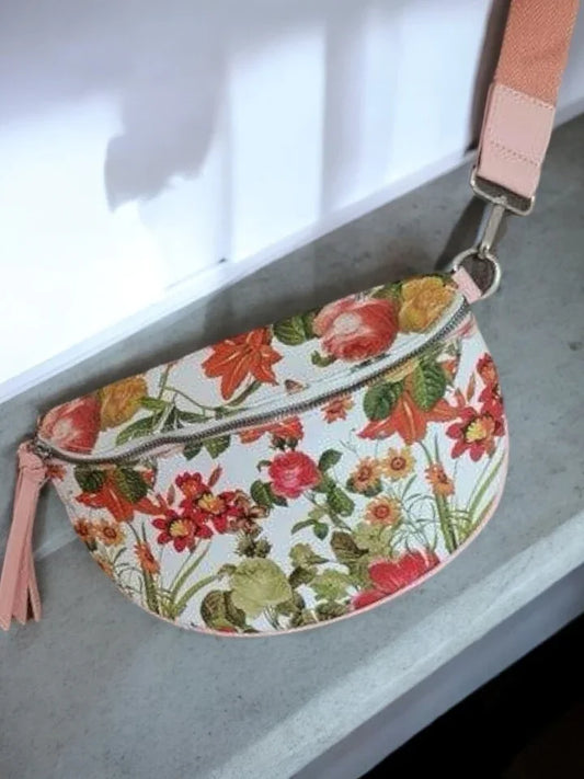 Floral print sac banane with pink strap from Le Petit Placard on a marble surface