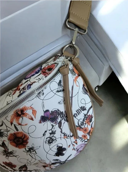 Floral print sac banane with tan strap from Le Petit Placard, accessory on white background