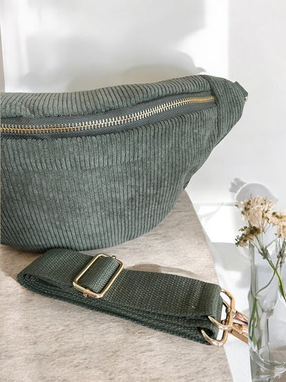 Green corduroy bum bag with gold zipper, detachable strap on table, Le Petit Placard accessory