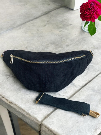 Black corduroy bum bag with gold zipper on a stone table, Le Petit Placard accessories