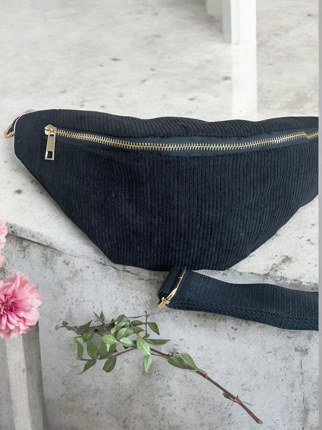 Black corduroy bum bag with gold zipper on stone surface, Le Petit Placard accessory