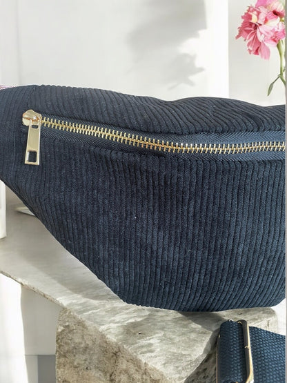Navy blue corduroy bum bag with gold zipper on marble surface, trendy accessory at Le Petit Placard