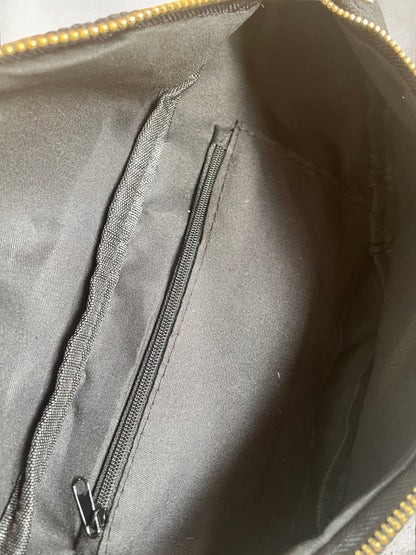 Interior of black zippered bag with fabric lining and inner pocket, Le Petit Placard accessories