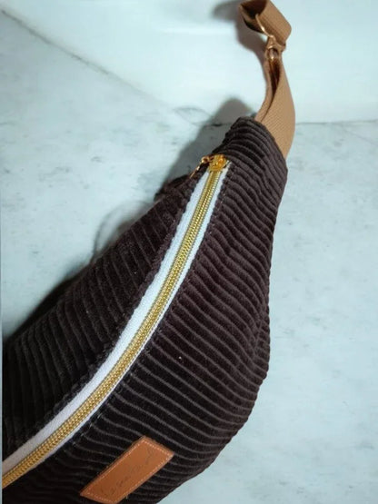 Brown corduroy bum bag with gold zipper and tan strap on marble surface, Le Petit Placard