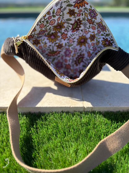 Open corduroy bum bag with floral lining from Le Petit Placard by the pool on grass