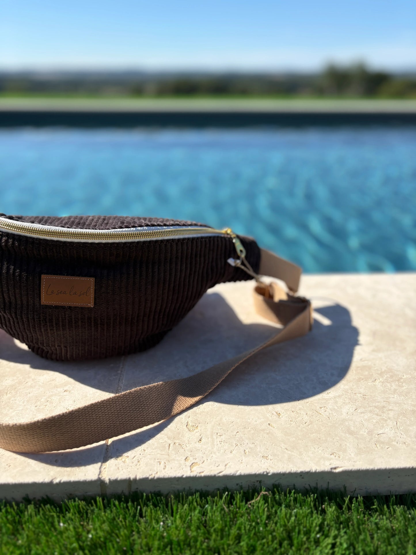 Brown corduroy fanny pack with gold zipper by the pool at Le Petit Placard boutique