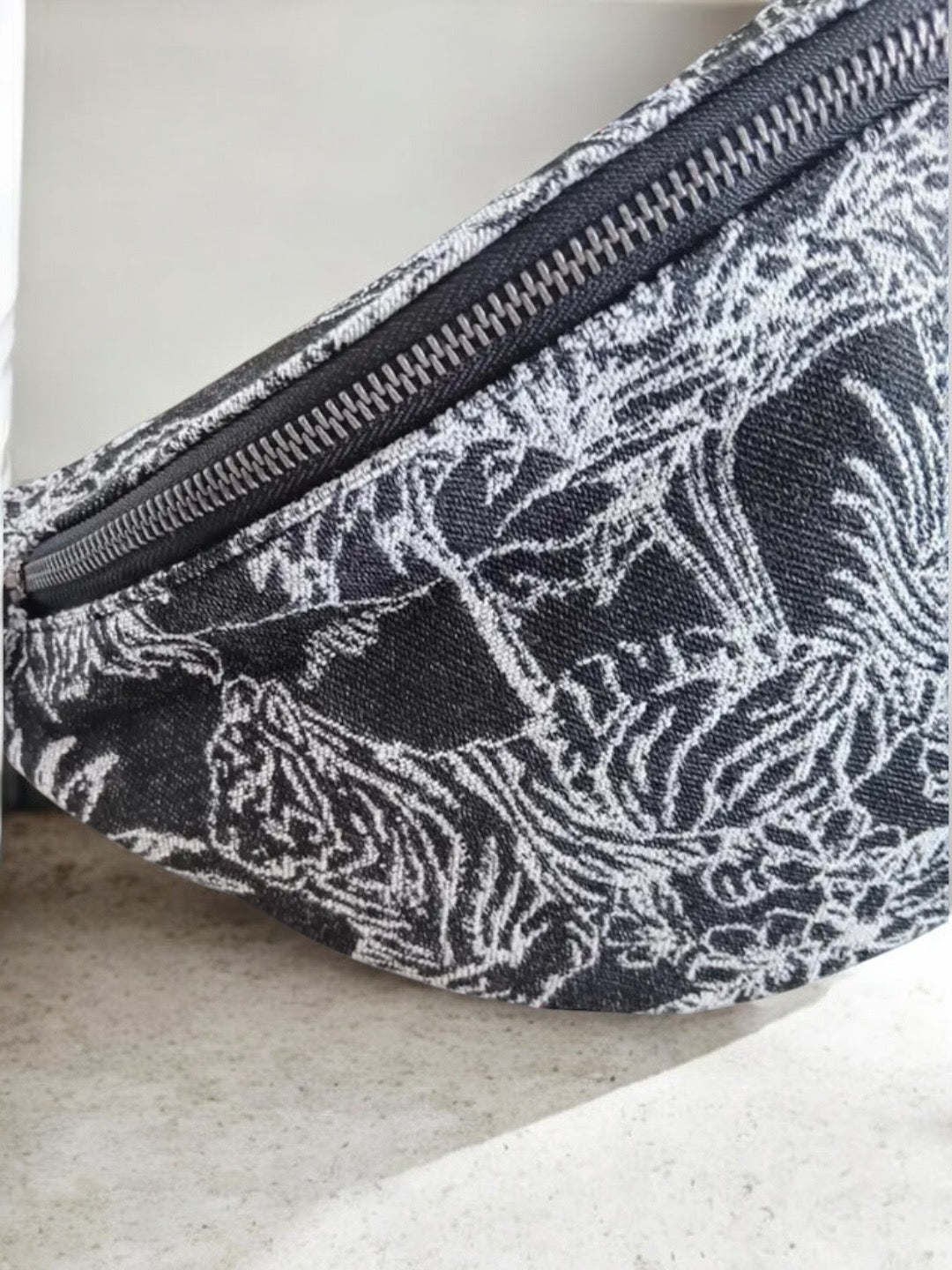 Close-up of black and white patterned sac banane with animal print at Le Petit Placard