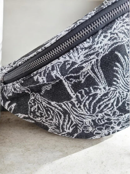 Close-up of black and white patterned sac banane with animal print at Le Petit Placard